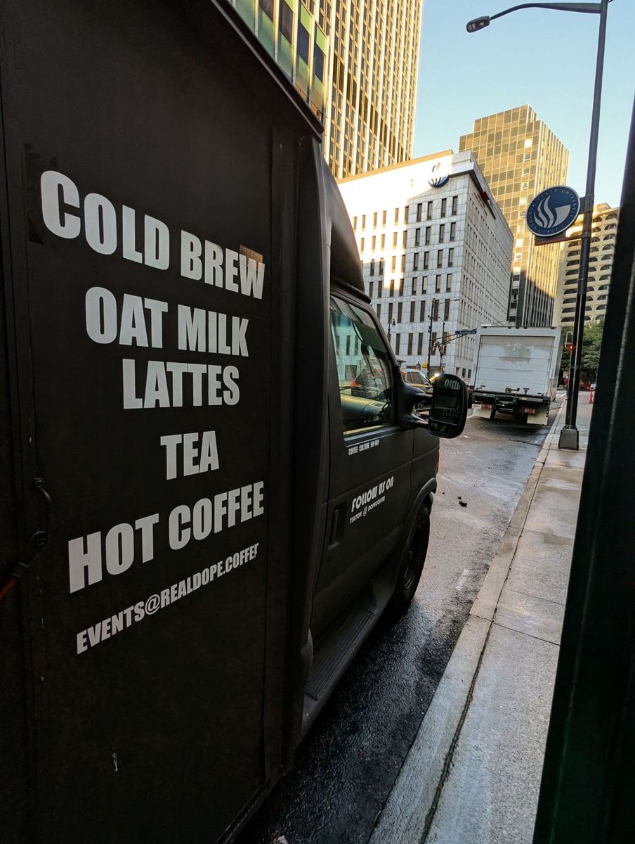 The Cold Brew Bus door menu: cold brew, oat milk lattes, tea, hot coffee